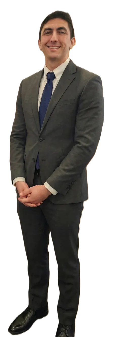 Full-length portrait of Angel Reyes, grant writing strategist, in a charcoal suit and navy tie